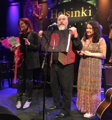 Dennis Pitts and Patricia Rose present Rosanne Cash with her courtesy flag to fly when she sails!