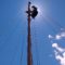 Rigger Becca in the sky checking shrouds and running gear.